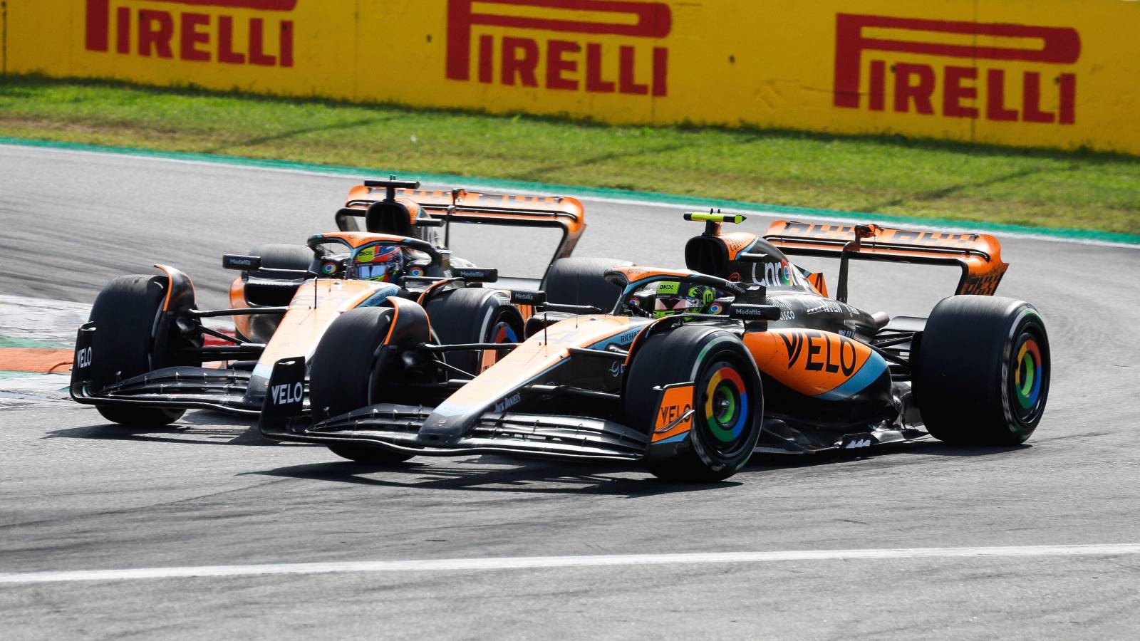 McLaren drivers Oscar Piastri and Lando Norris battle side by side on track during the 2025 Formula 1 championship season.